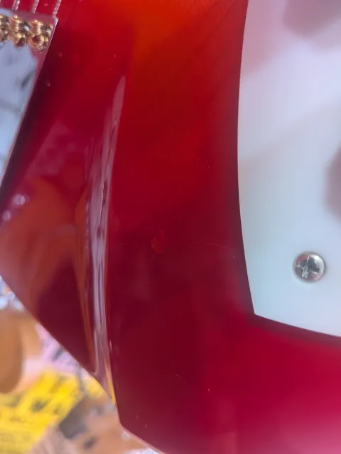 You can see the ding here, near the bottom of the pickguard.